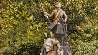 statue of joffrey above direwolf